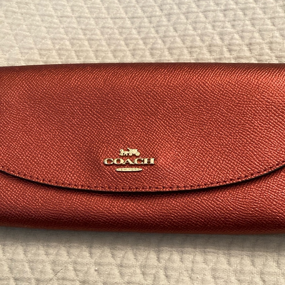 Shimmery red Coach wallet.  Never used.  Excellent condition.